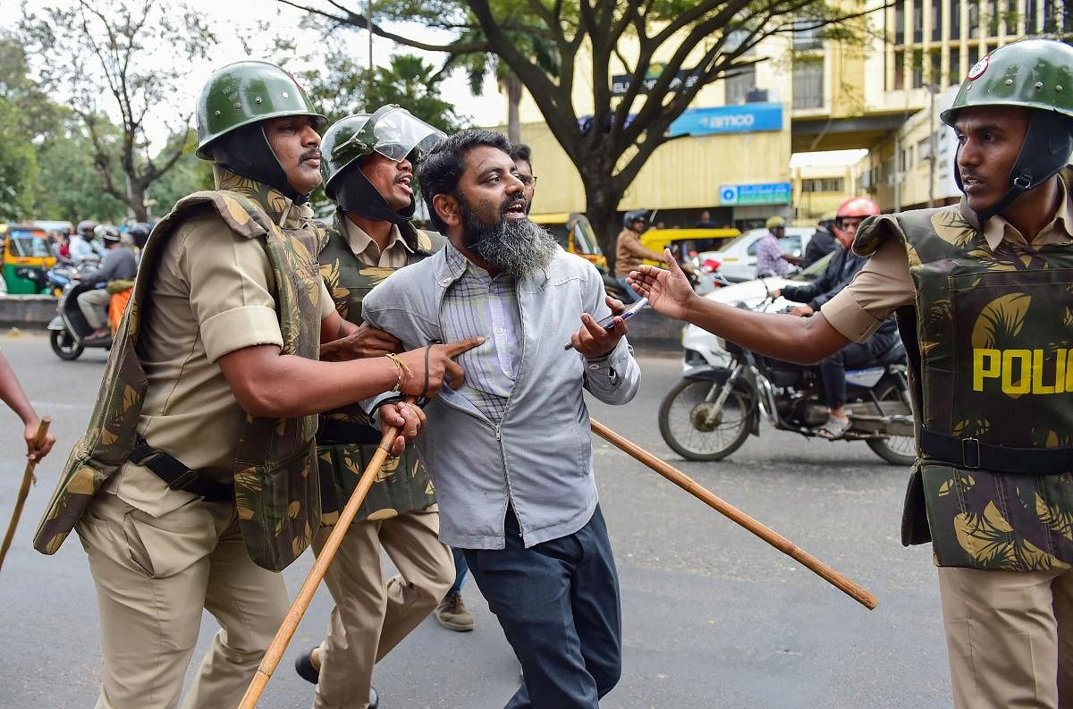 A protestor being detained by police personnel as he defies the prohibitory orders imposed in the area, during a rally against the amended Citizenship Act, in Bengaluru, Thursday, Dec. 19, 2019. (PTI Photo)