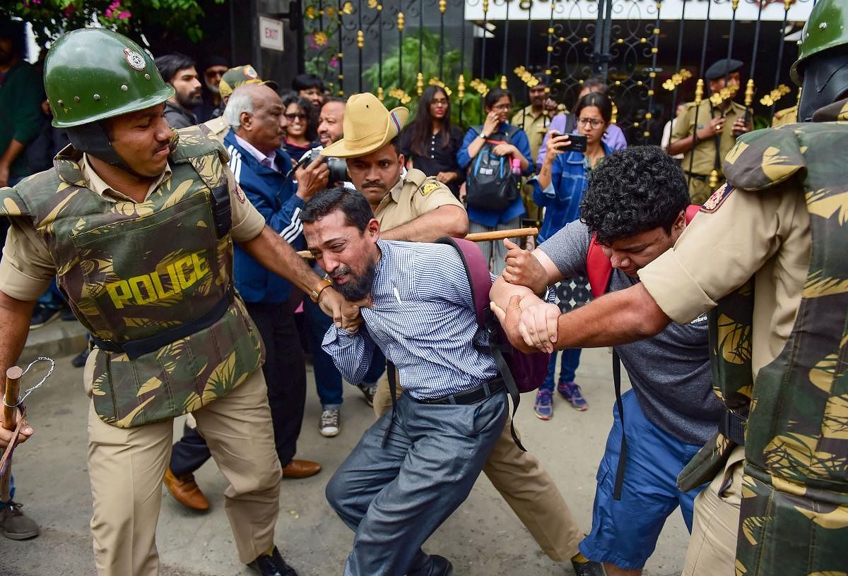 A protestor being detained by police personnel as he defies the prohibitory orders imposed in the area, during a rally against the amended Citizenship Act, in Bengaluru, Thursday, Dec. 19, 2019. (PTI Photo)