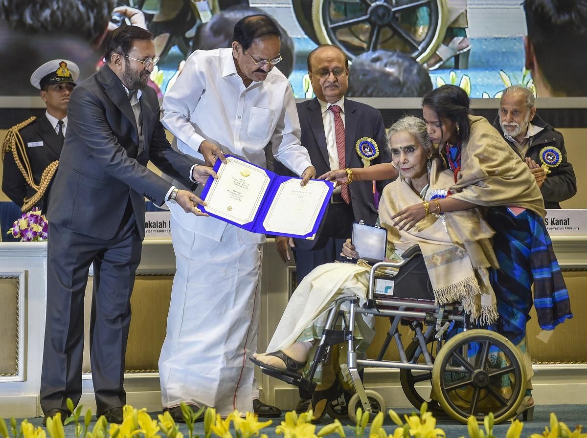 Vice President M Venkaiah Naidu presents Best Supporting Actress award to actress Surekha Sikri for her role in the film 'Badhaai Ho' during the 66th National Film Awards function at Vigyan Bhavan in New Delhi, Monday, Dec. 23, 2019. Union I&B Minister Prakash Javadekar is also seen. (PTI Photo)