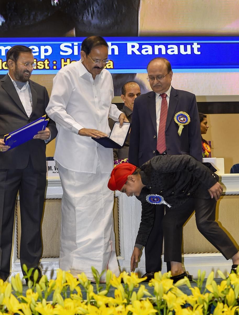 Vice President M Venkaiah Naidu presents the award for Best Child Artist to Sampeep Ranaut during the 66th National Film Awards function at Vigyan Bhavan in New Delhi, Monday, Dec. 23, 2019. Union Minister Prakash Javadekar is also seen. (PTI Photo)