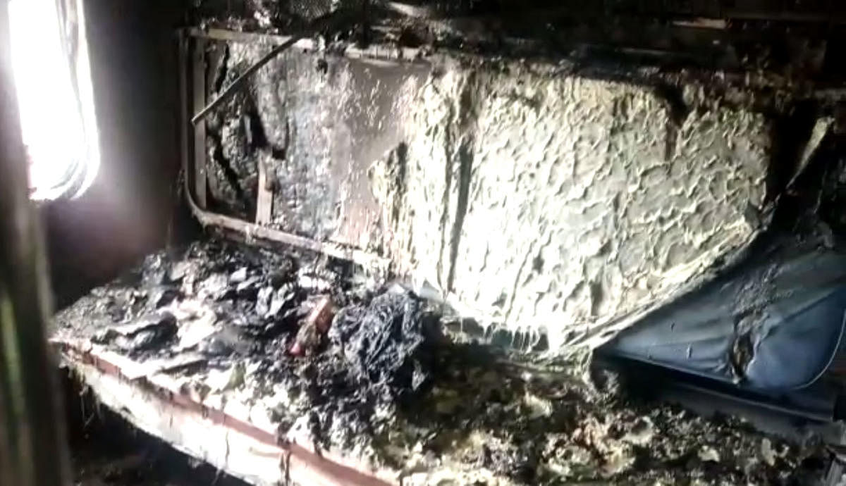 A video grab of a burnt air-conditioned coach of a train at Chikkabanavara railway station on Thursday. 