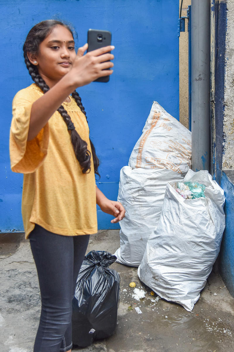 A volunteer poses with bags of trash. DH PHOTO/S K DINESH
