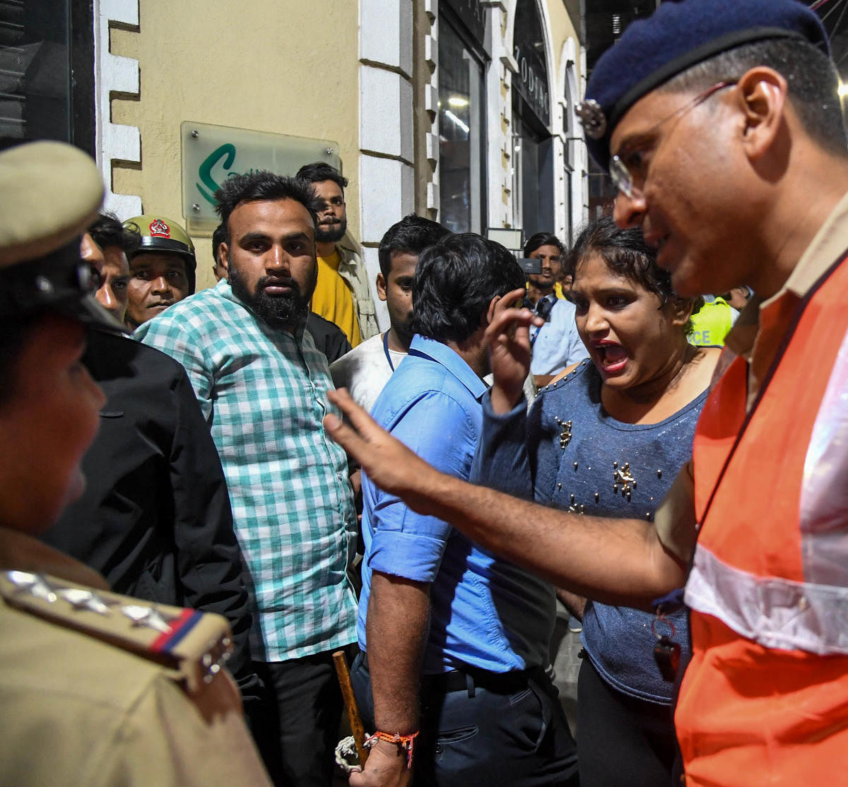 DCP (Central) Chetan Singh Rathore tries to calm down revellers. DH PHOTO/B H SHIVAKUMAR