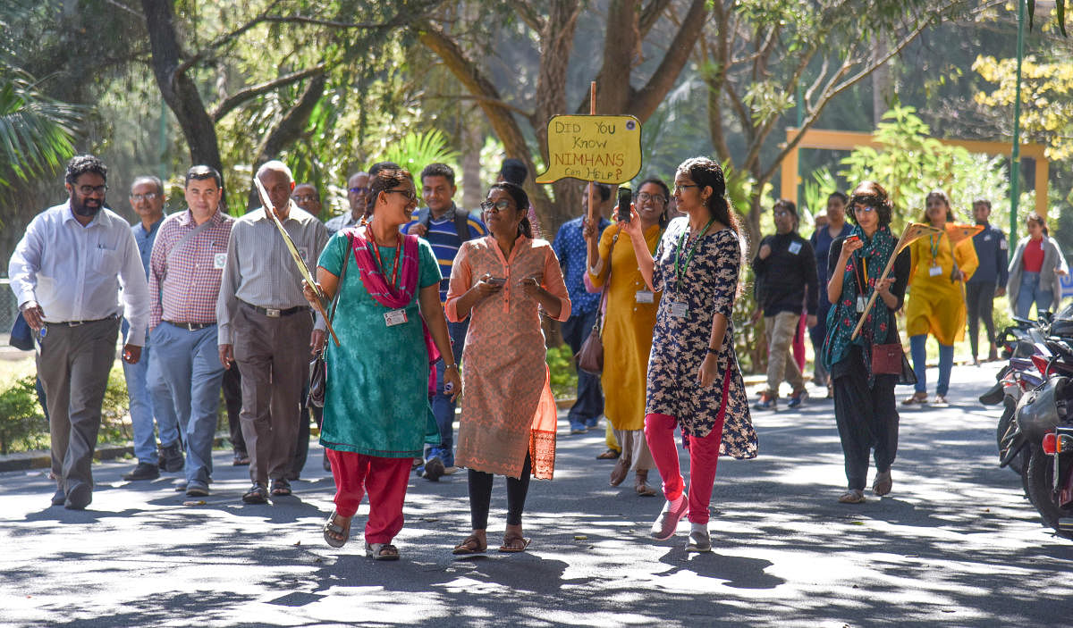 People take part in ‘Stories against stigma’, a walking tour of Nimhans on Saturday. The tour was aimed at dispelling stereotypes about mental health disorders. DH PHOTO/S K DINESH