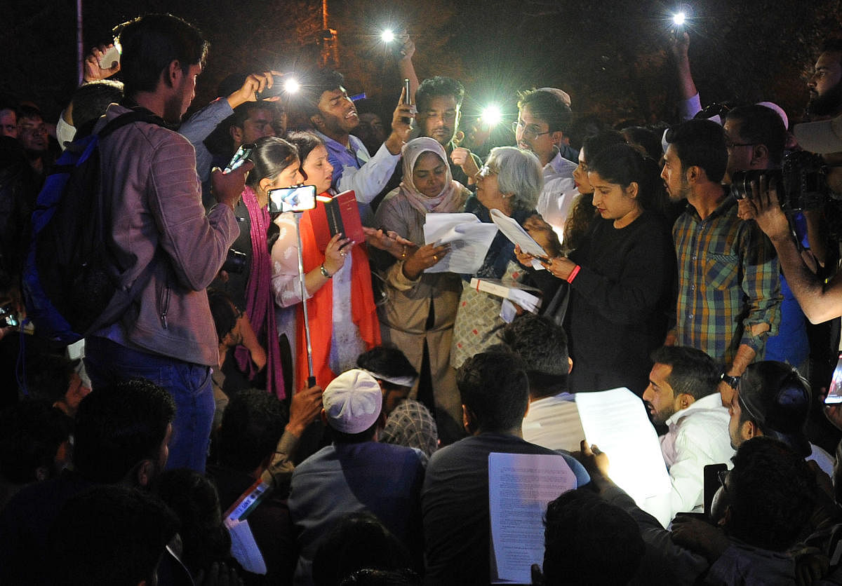 At the end of the protest against the CAA at Town Hall on Saturday, a few people stayed back to read the Constitution. DH PHOTO/Pushkar V