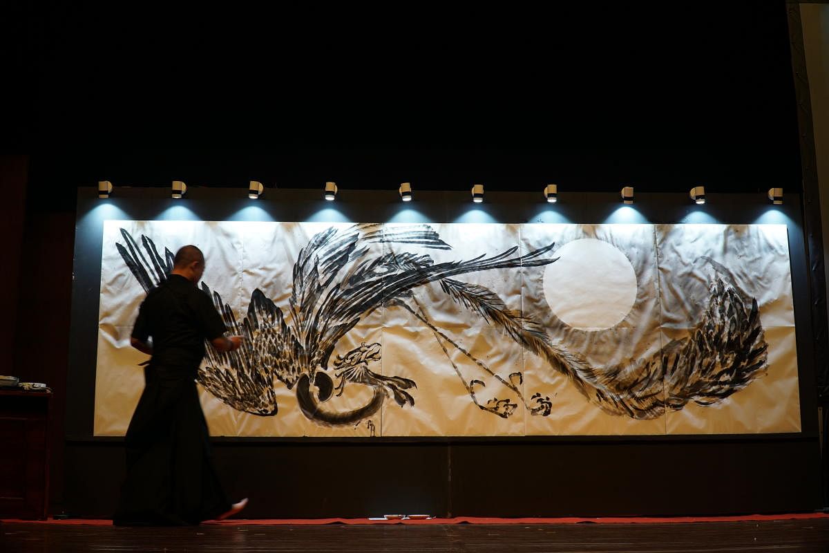Japanese traditional artist, Shukou Tsuchiya, paints a Japanese phoenix on a sprawling 17 foot by 4 five-foot canvas, to symbolise what he said was the “the India-Japan connection,” at Japan Habba on Sunday.
