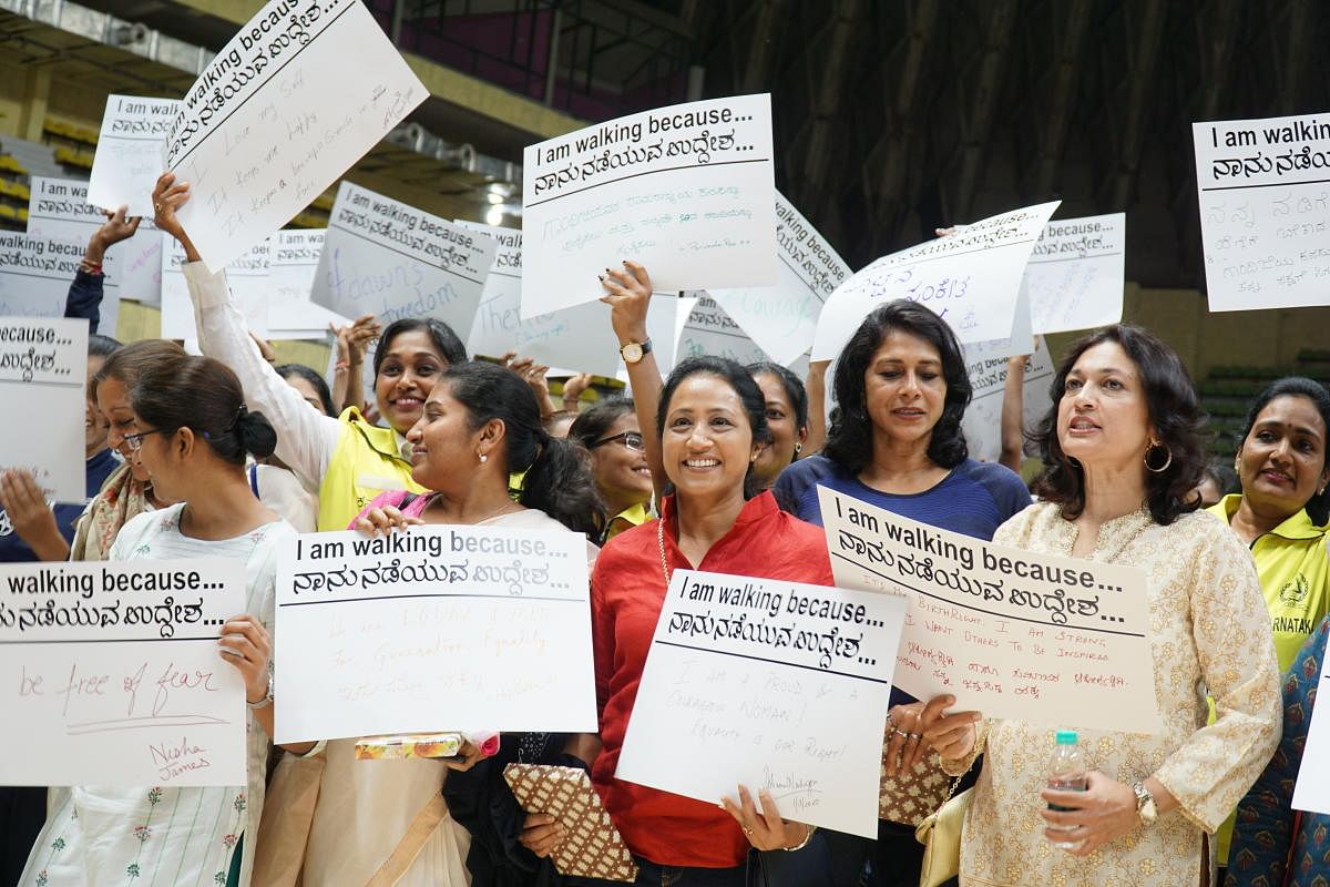 Women hold placards before the start of Power 2020 on the night of March 1, 2020. The women wearing red is Ashini Nachappa, the lady in blue is athlete Reeth Abraham and the lady in white on the right is actor Suman Nagarkar.
