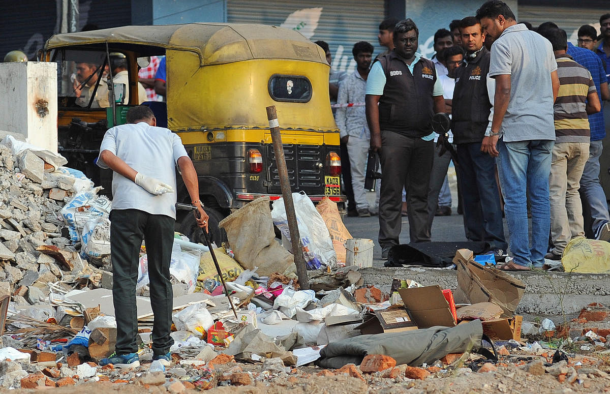 Bomb and forensic experts inspect the blast site in Adugodi on Sunday. DH PhotoS/ Pushkar V