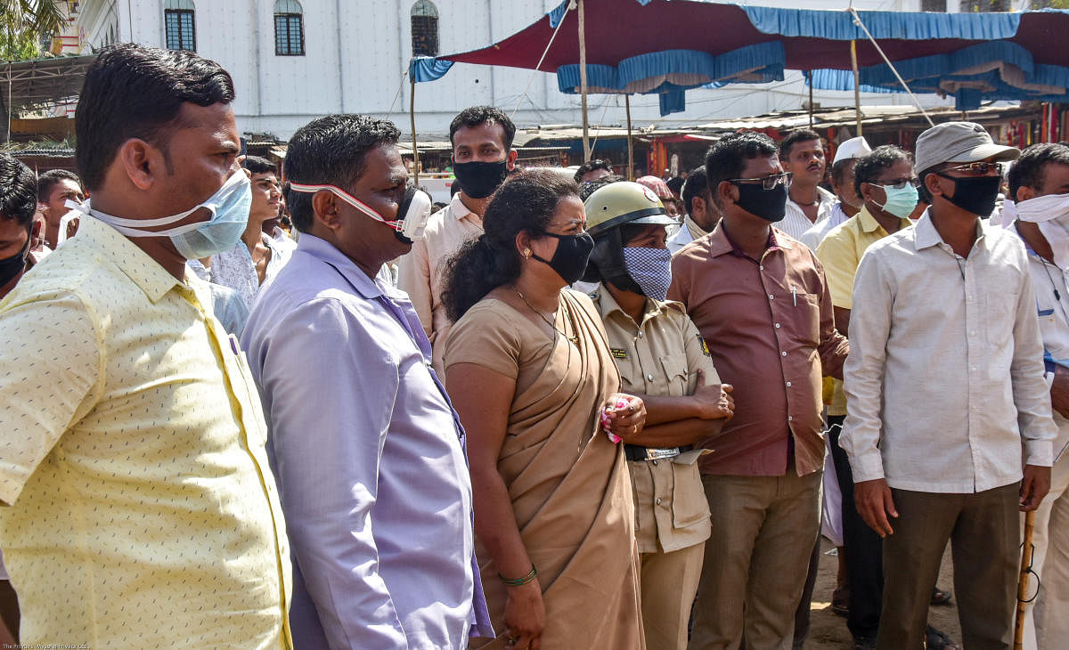 Thousands of devotees took part in Sharanabasaveshwara Rathotsava in Kalaburagi on Friday. (Right) Devotees and police wore masks in the wake of Covid-19 scare.