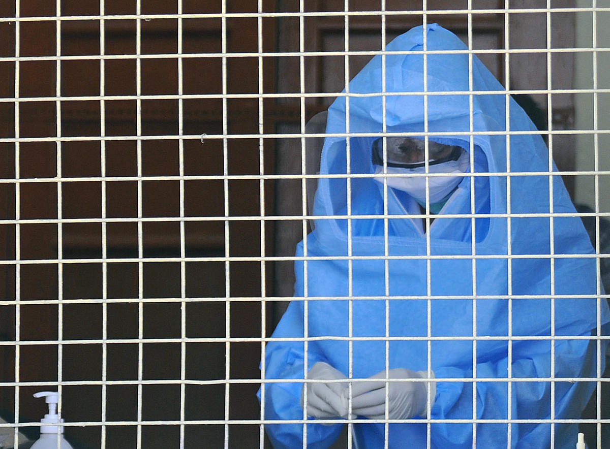 A medical staff with medical body suit seen at COVID-19 and Infectious Diseases Screening Center at Victoria Hospital, Bengaluru on Tuesday. DH Photo/ Pushkar V