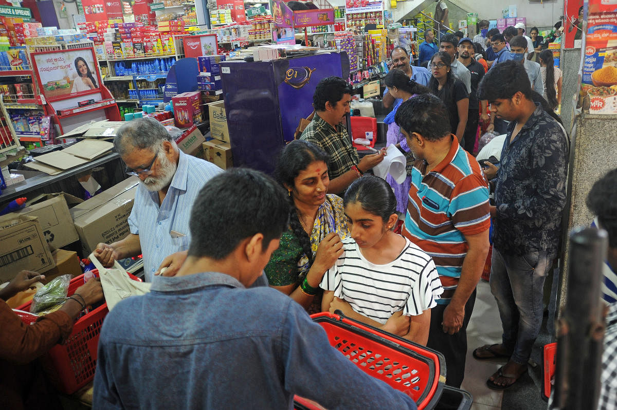People shop for groceries at a store on Coconut Avenue Road, Malleswaram, Bengaluru, on Friday. DH Photo/ Pushkar V