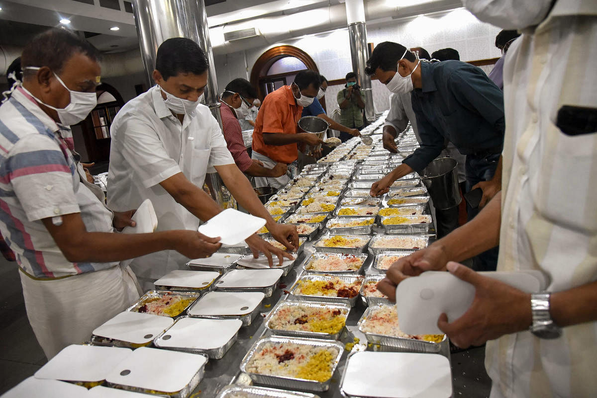 Volunteers pack food packets to distribute at government hospitals and among poor people, during the complete lockdown across the country to contain to contain the coronavirus spread, at Ernakulam Karayogam in Kochi. (PTI Photo)