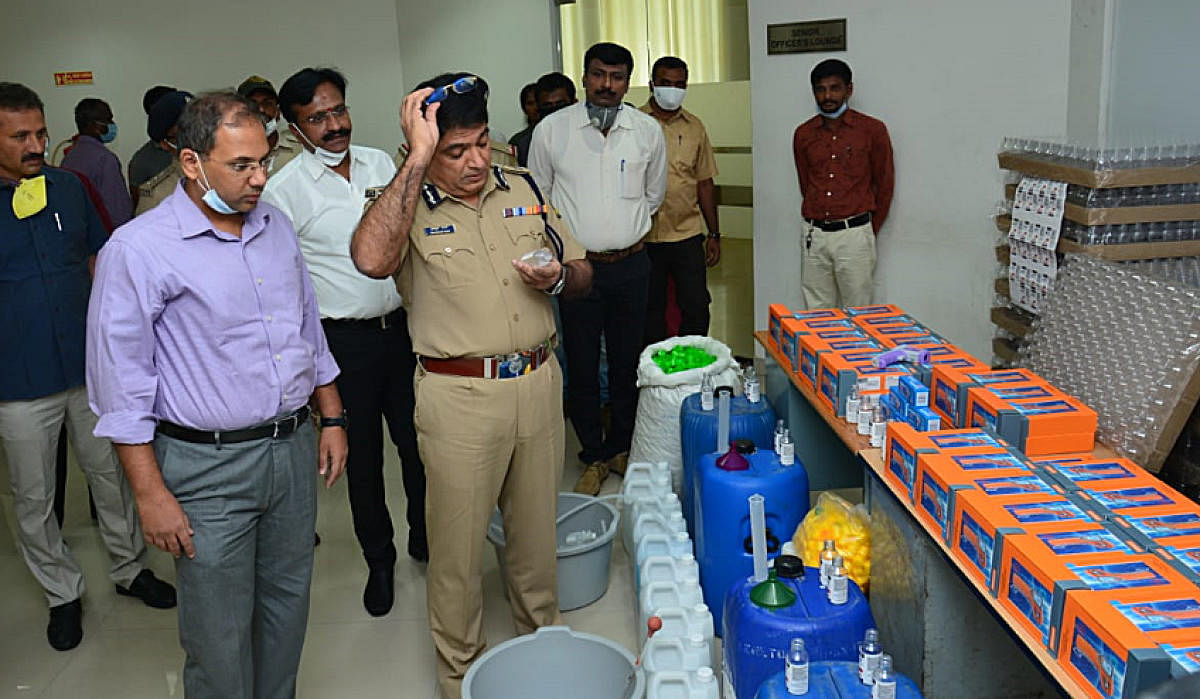 City police chief Bhaskar Rao inspects the fake infrared thermometers and hand sanitisers. 