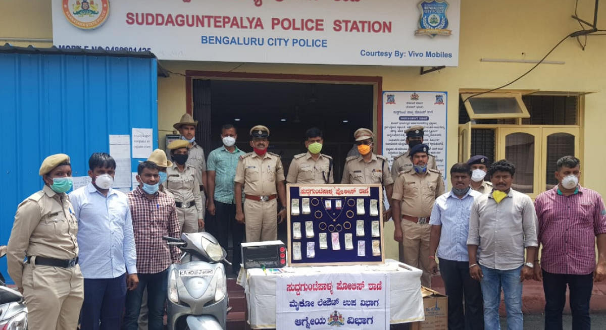 The Suddaguntepalya police with the valuables recovered from Syed Masood. Special arrangement