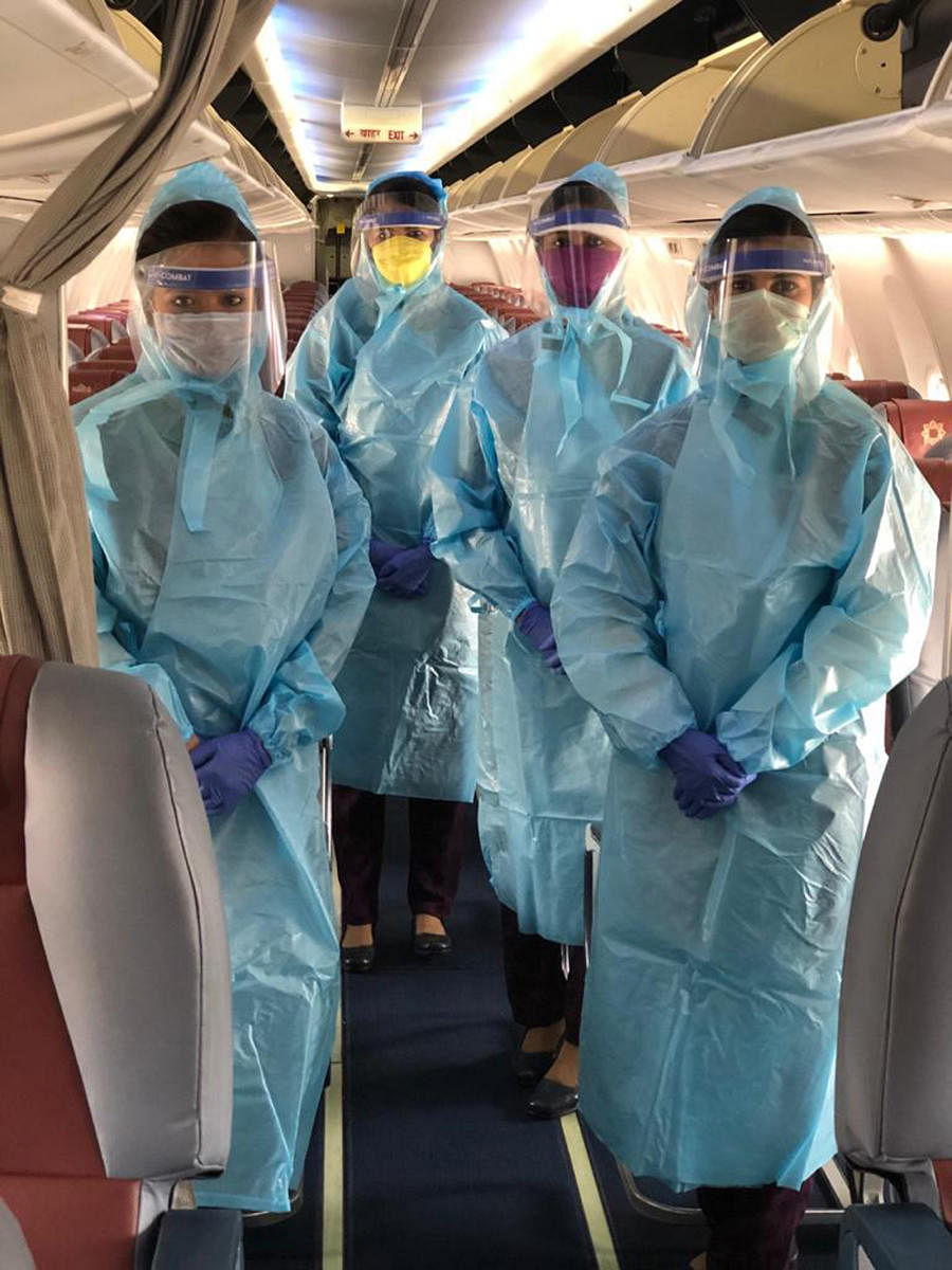 The cabin crew of Vistara wear protective gowns, face masks, and face shields during flight operations.