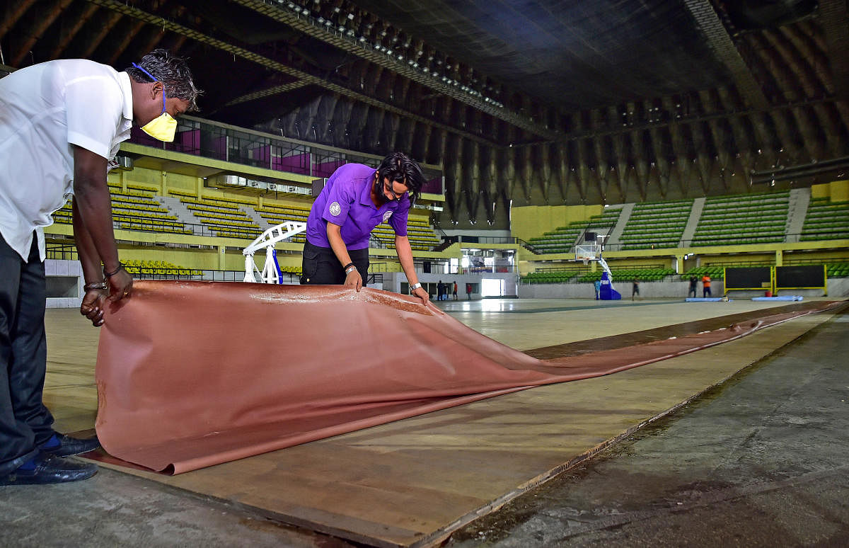 Just before the BBMP ditched Kanteerava as a Covid centre, workers were busy making the stadium ready. DH PHOTO/RANJU P