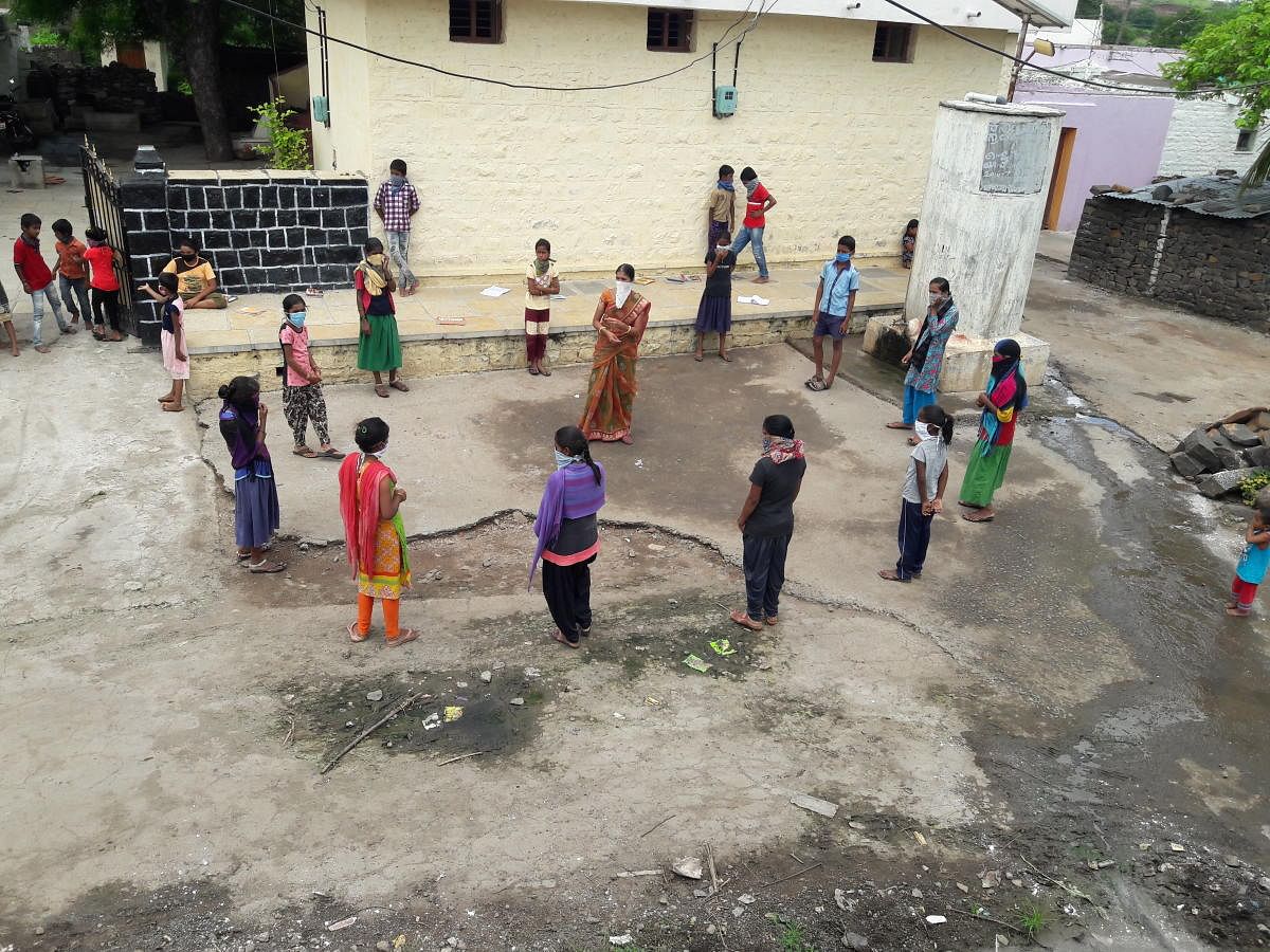 Teachers and children in Okali village in Kalaburagi district; children playing during leisure time.  