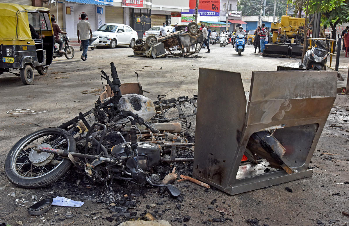 Vehicles burnt by the rampaging mob in DJ Halli.