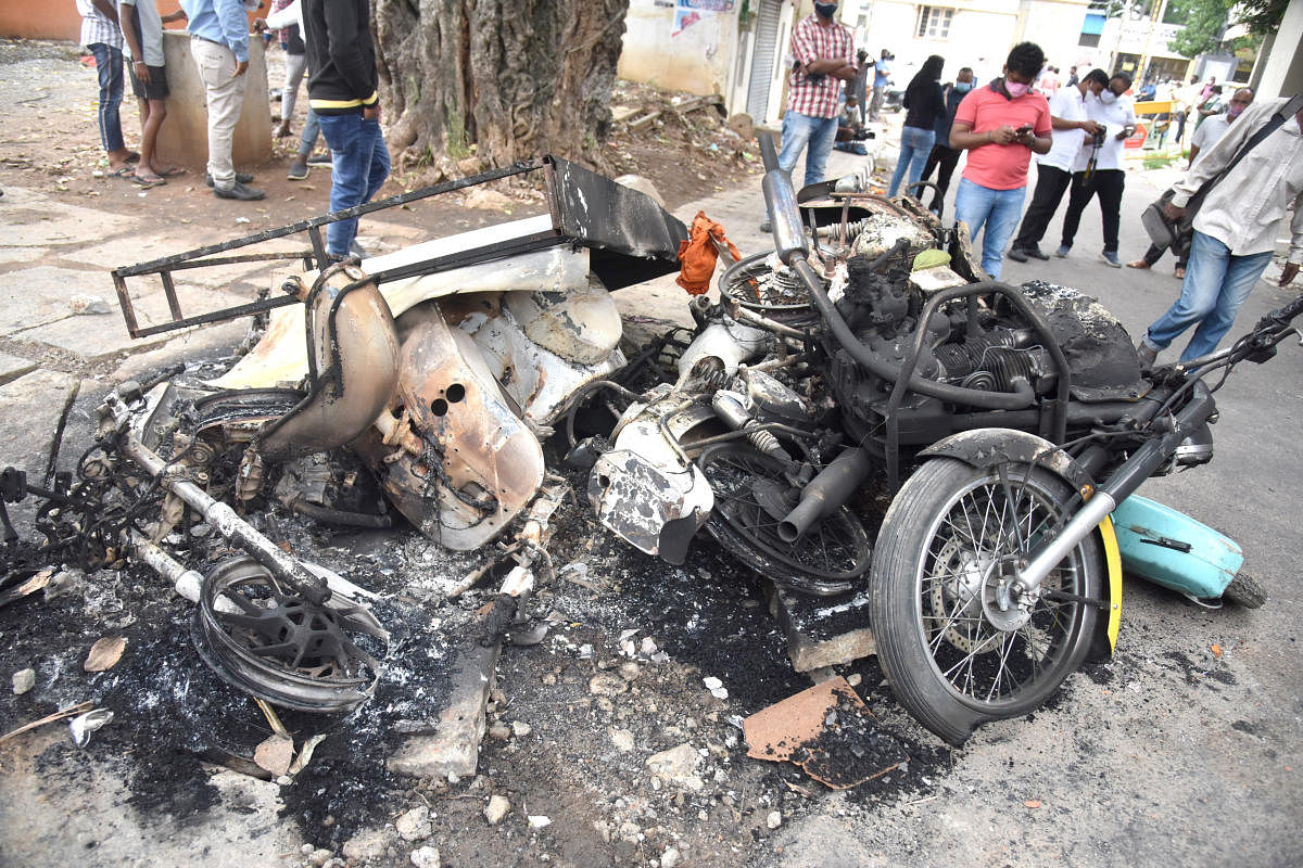 Vehicles burnt by the violent mob on Tuesday incident at Kaval Byrasandra in Bengaluru on Wednesday, 12 August 2020. Photo by S K Dinesh