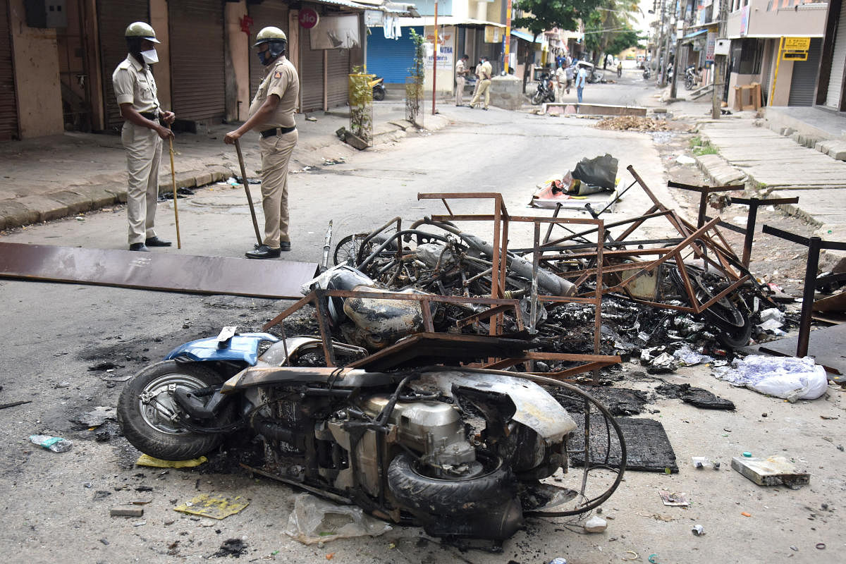 Vehicles burnt by the violent mob on Tuesday incident at Kaval Byrasandra in Bengaluru on Wednesday, 12 August 2020. Photo by S K Dinesh