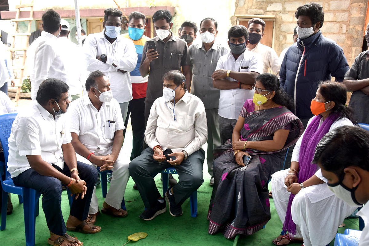 The MLA interacts with supporters outside his home. DH PHOTO/S K DINESH