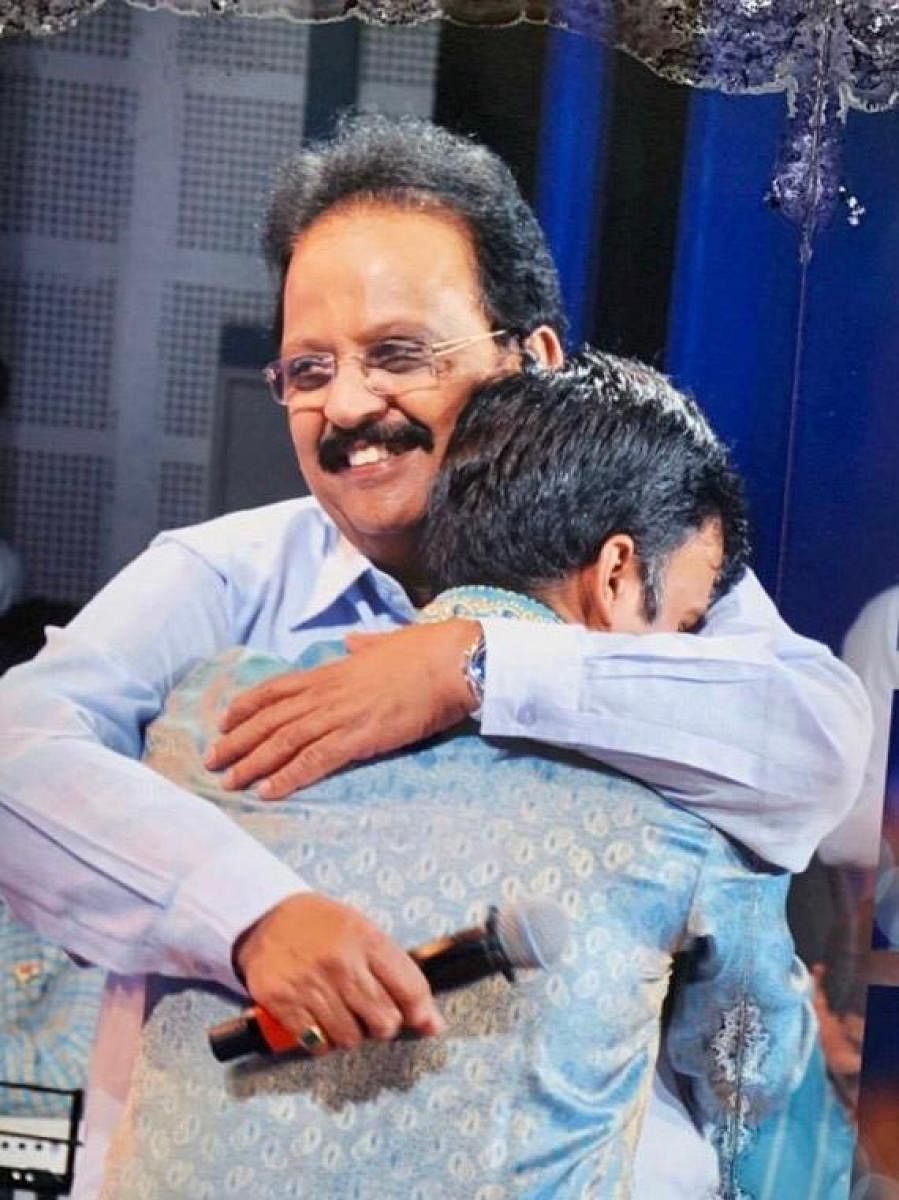 A fan hugs S P Balasubrahmanyam at a programme at Brahmavar in 2015.