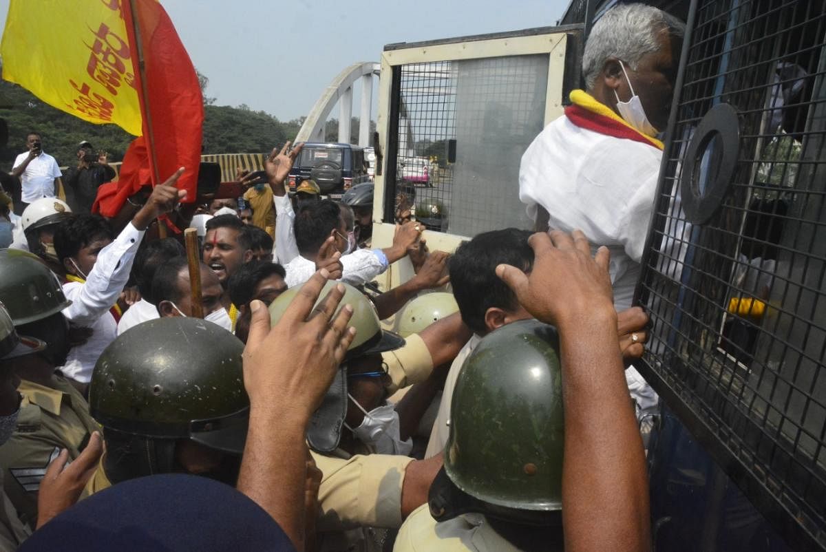 The Belagavi police detain Kannada activists, who staged a protest condemning the MES meeting, on Sunday. DH PHOTOS