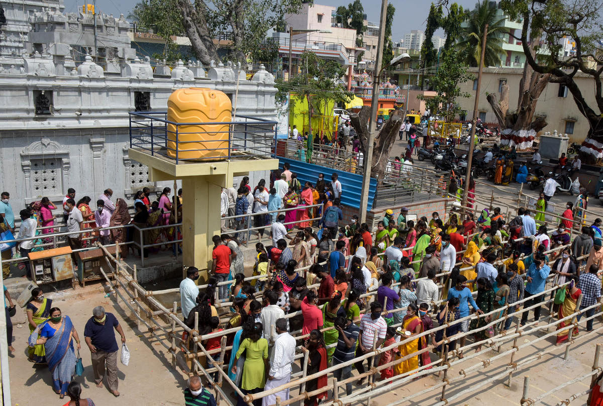 Public places have been witnessing high footfall in view of the festival season. The picture is from a temple in T Dasarahalli during the Bagalagunte Maramma fair on Monday. DH PHOTO/B H SHIVAKUMAR