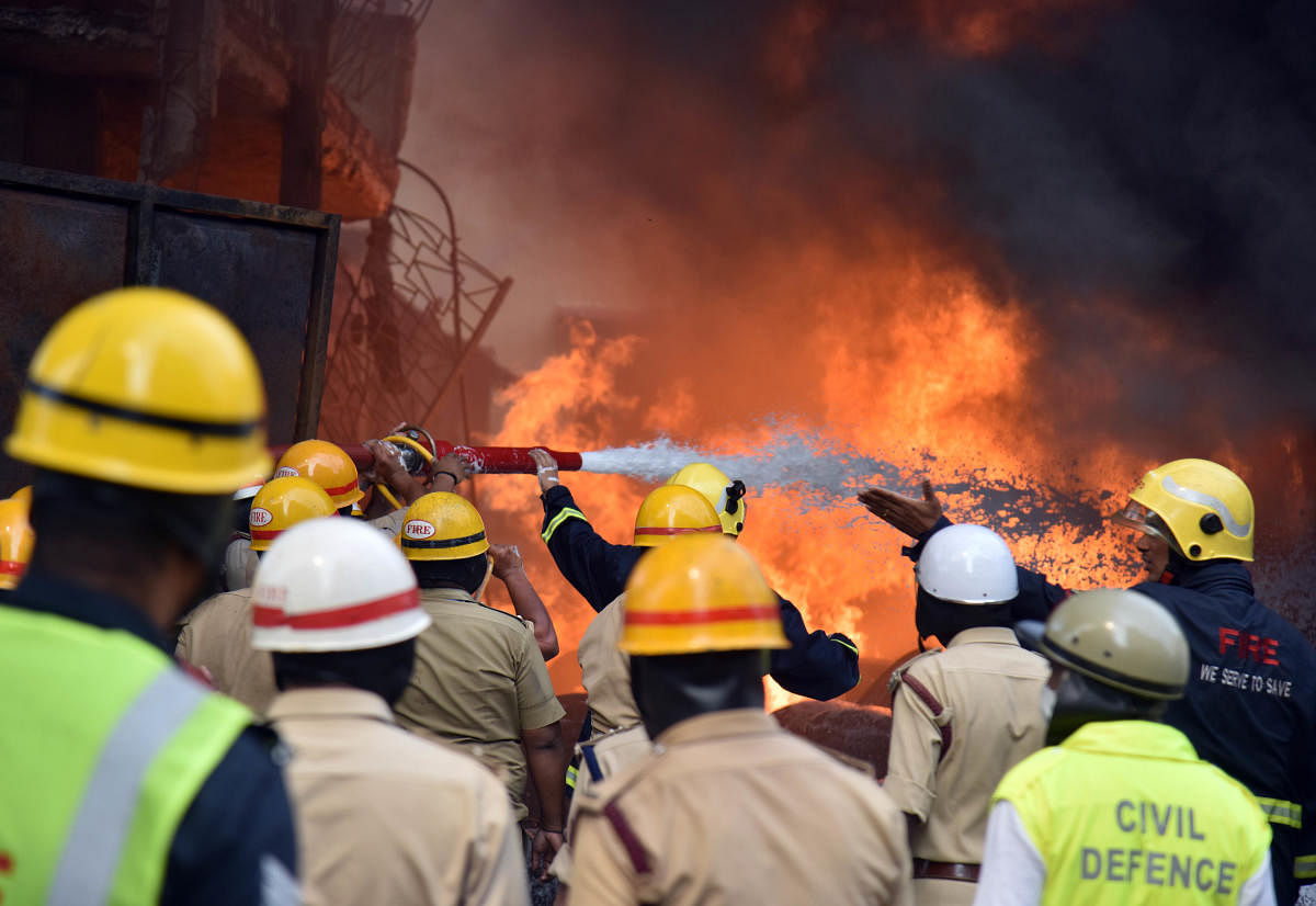 Firefighters at work to douse the fire. DH PHOTO/JANARDHAN B K