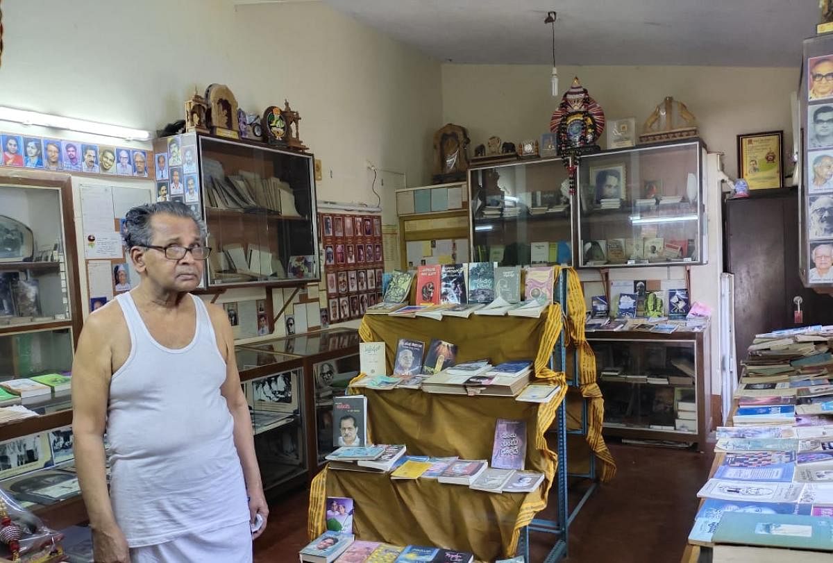 Vishnu Naik standing next to his collection in his house in Ankola. Photos by author