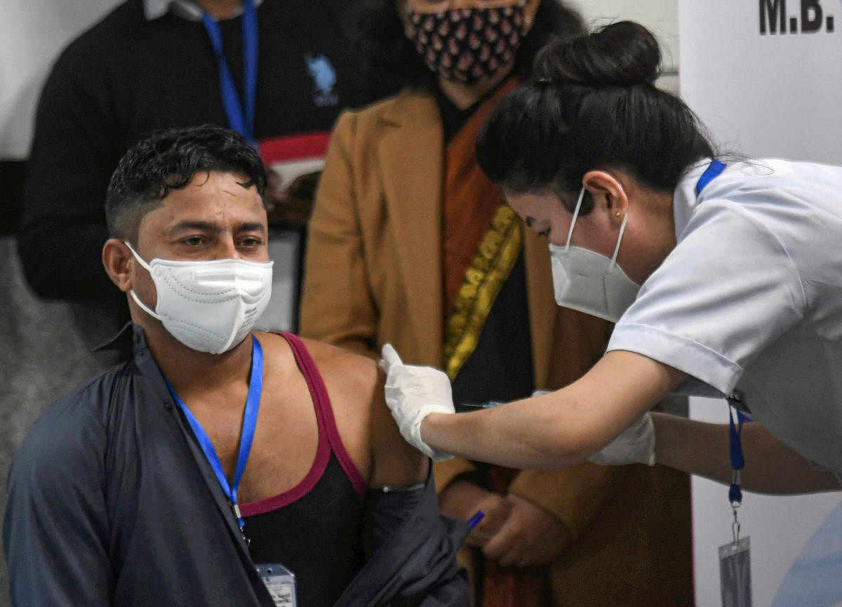 A medic administers the first dose of Covishield vaccine to a frontline worker. PTI 