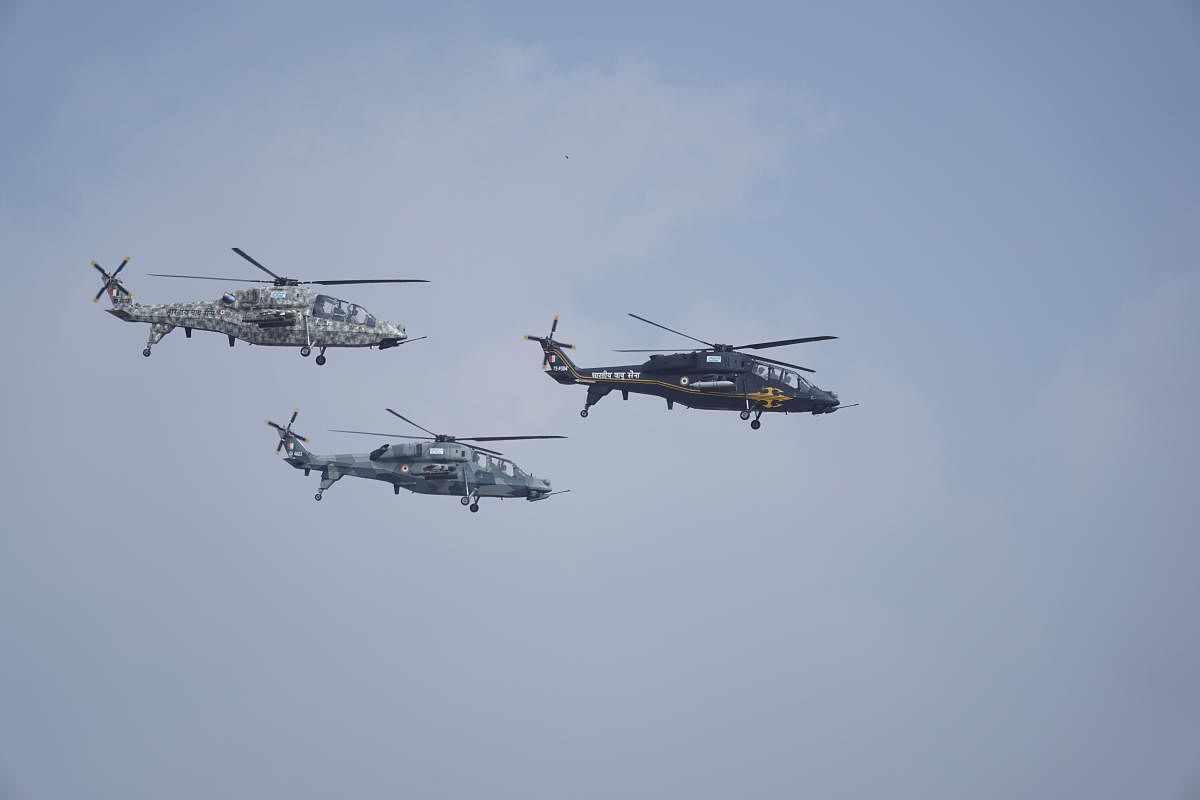 Three HAL-made light combat helicopters (LCHs) fly during the inaugural day of the 13th edition of the air show in Bengaluru on Wednesday.
