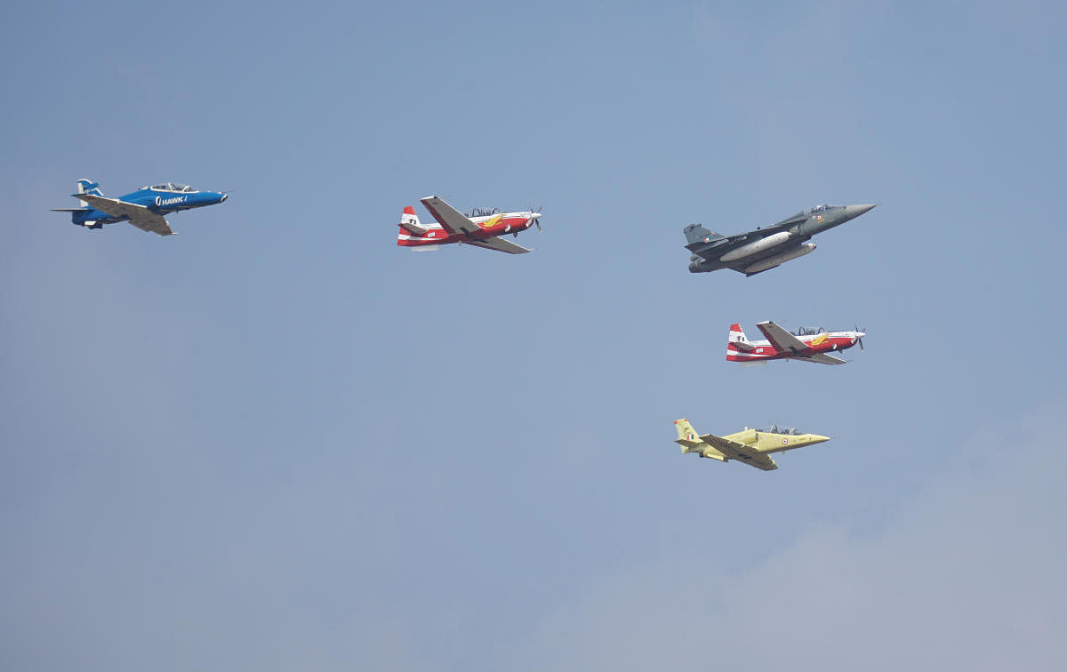 Five indigenously built aircraft - (from L to R) Hawk, HTT-40, Tejas, HTT-40 and the IJT - participate in HAL's Atmanirbhar Bharat flight at Aero India 2021 on Wednesday.