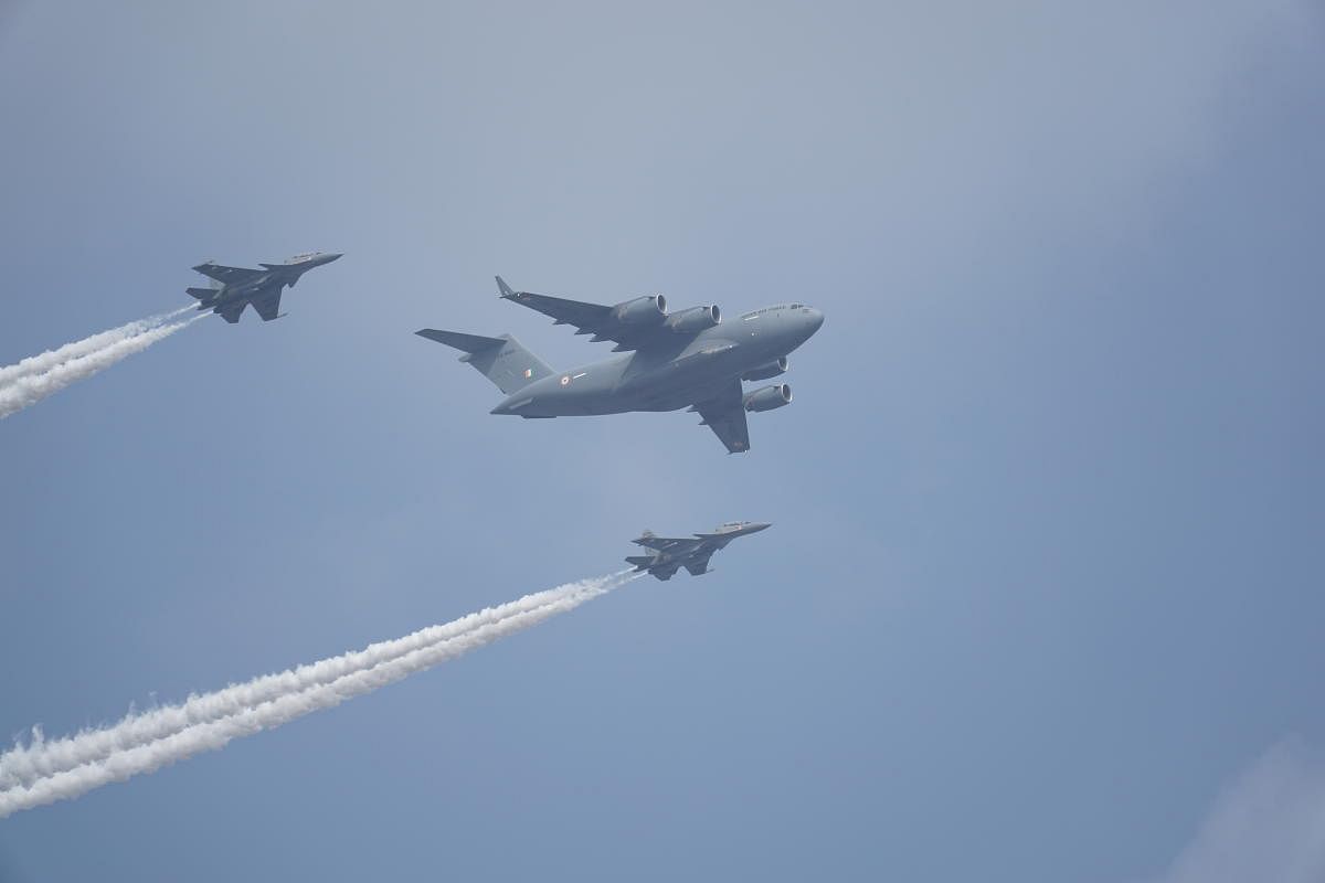 Two Sukhois flank a C-17 during the airshow at Aero India 2021 on Wednesday.
