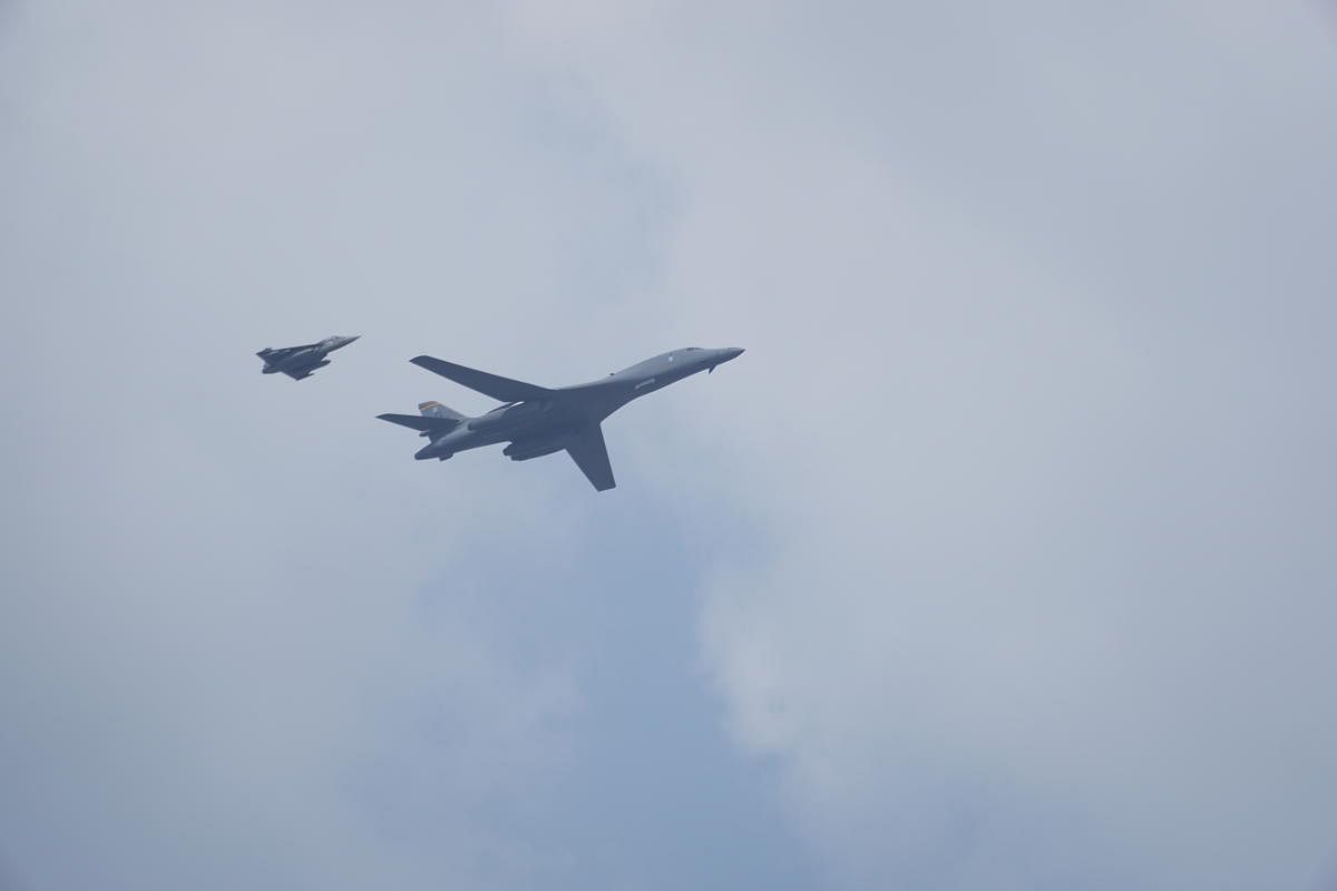 A US Air Force B-1 Lancer of the 34th Expeditionary group flies over Yelahanka Air Force base, while escorted by a Tejas on the inaugural day of Aero India on Wednesday.