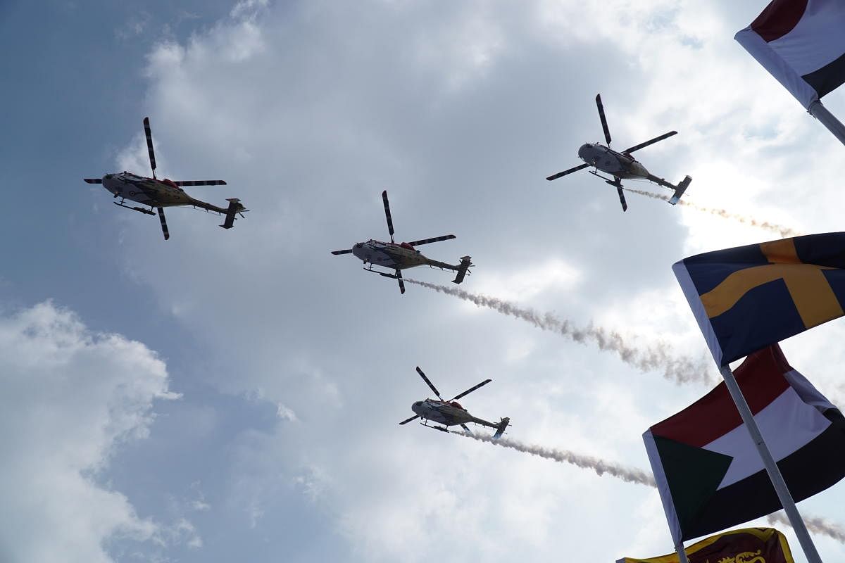 ALHs of the Sarang Air Display team fly over the Yelahanka Air Force base during Aero India 2021 on Wednesday.