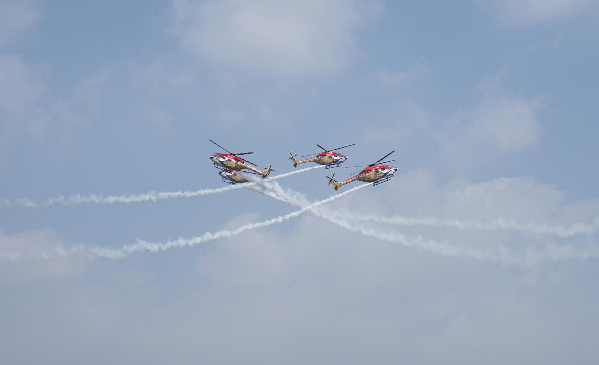 Advanced light helicopters of the famed Sarang aerobatic team carry out a criss-cross manoeuvre on Day One of the 13th edition of air show on Wednesday.