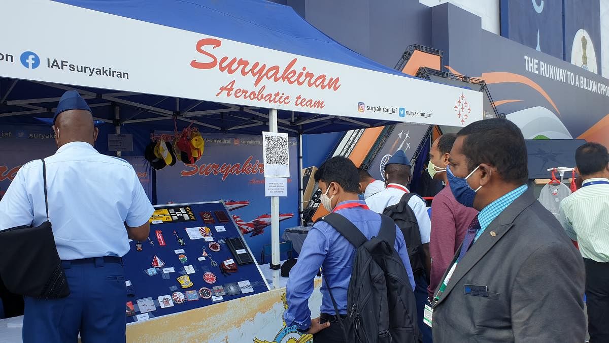 Visitors throng a pavilion where a range of Suryakiran aerobatic team’s merchandise is up for grabs at the air show venue. 