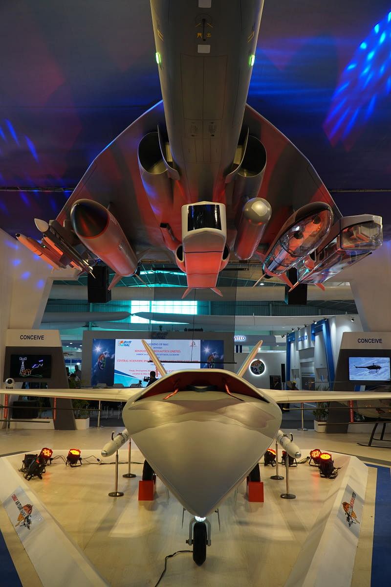HAL's unmanned loyal wingman project, showing a CATS Warrior drone (bottom), and a mockup of the Tejas above it showing how secondary and smaller attack drones would be carried - in pods. Photo taken at Aero india 2021 on February 4