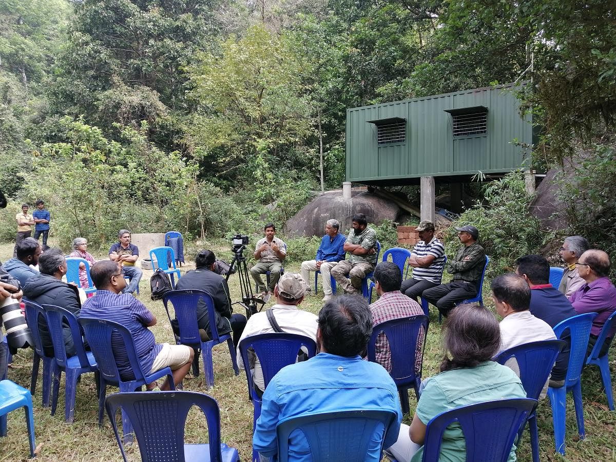 Researchers and wildlife enthusiasts at Ashokavana in Bisle forest range, Sakleshpur taluk. The container home, Kappe Goodu, is seen at the background.  Photo courtesy: Abhaya Simha
