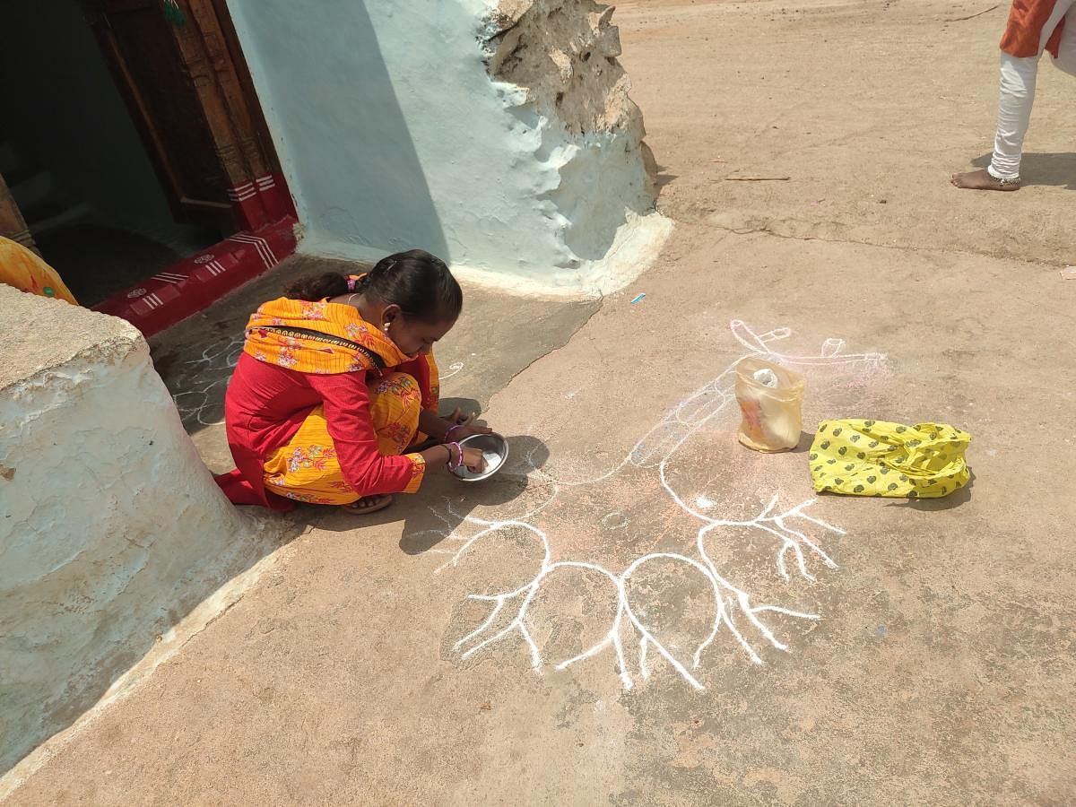 A student of Government High School at Talkeri in Yelburga taluk of Koppal district draws Science diagrams as Rangoli in front of her house.