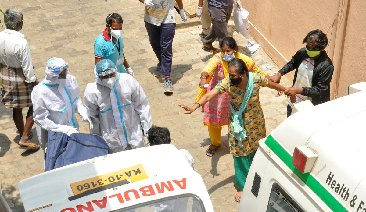 Bodies being shifted in ambulances at the District Covid Hospital in Chamarajanagar on Monday. DH Photo