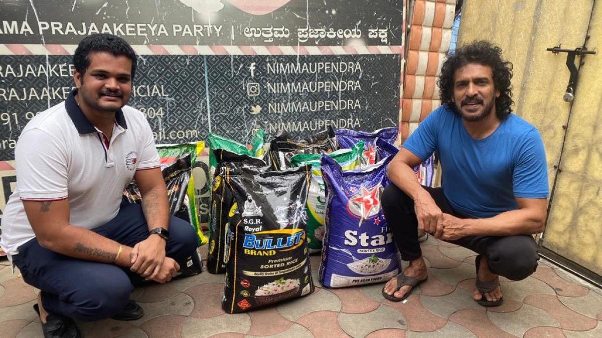 Actor Upendra with the grocery kits provided to beneficiaries. DH Photo