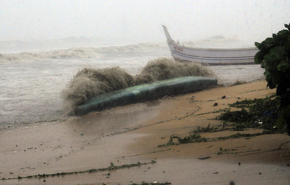 A boat is washed away in the turbulent waters at Malpe beach near Udupi.