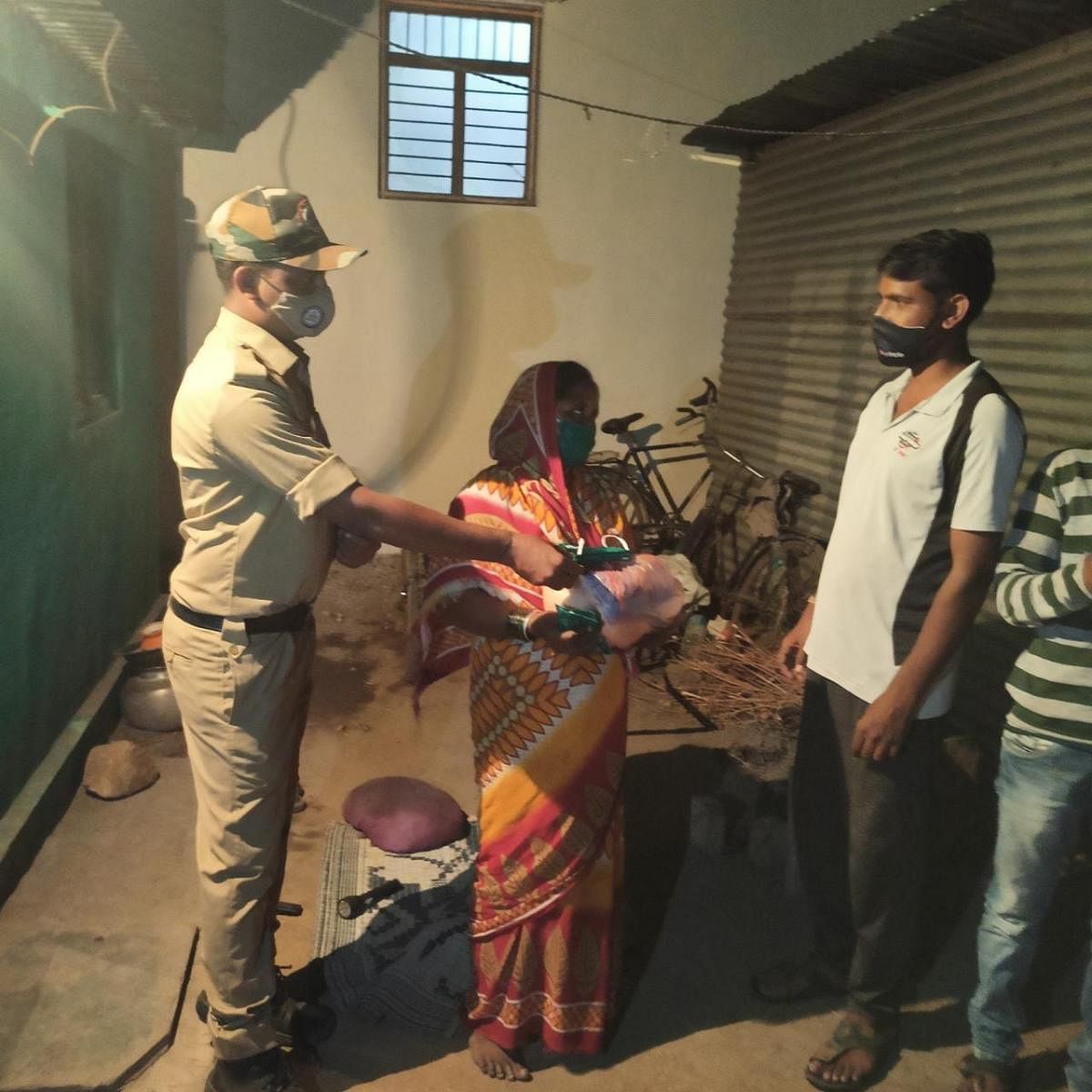 Police constable Dayanand gives food to the needy in Surpur in Yadgir district.