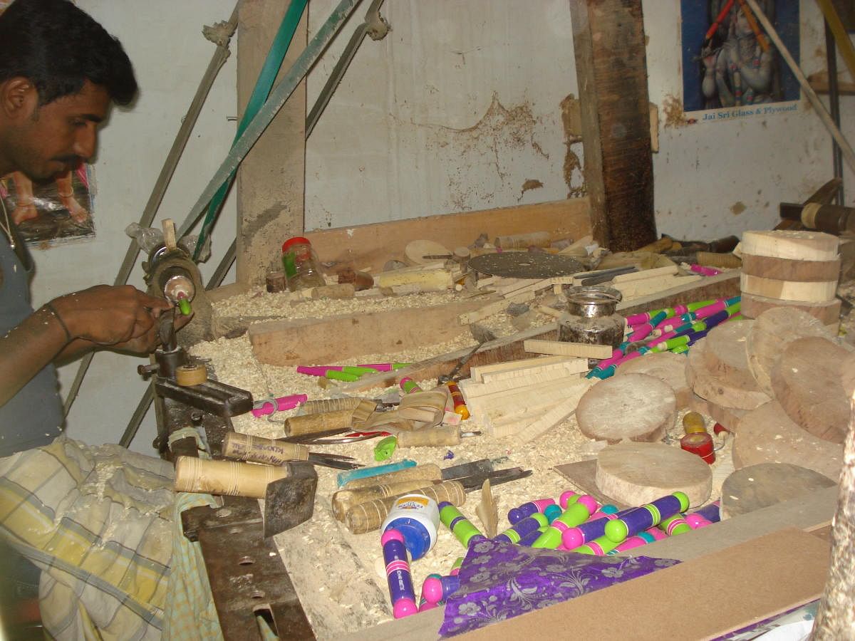An artisan making traditional games and toys at Channapatna.
