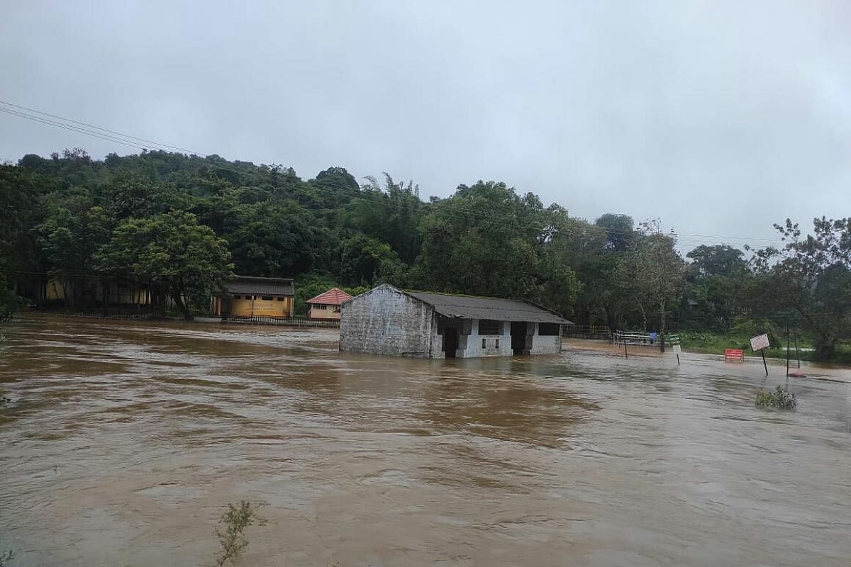 The bathing ghat at Triveni Sangama in Bhagamandala of Kodagu district is under water. DH Photo