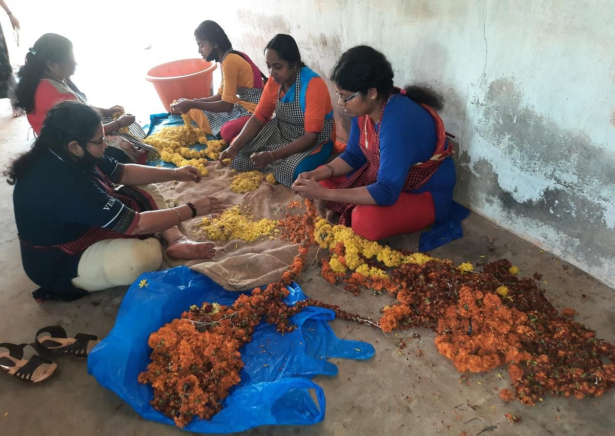 Women segregate used marigold sourced from temples for colour dye extraction in Udupi. Credit: Mamatha Rai