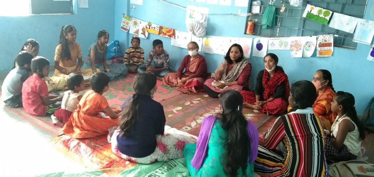 Students engaging in a discussion with educationist Indira Vijaysimha (in sari).