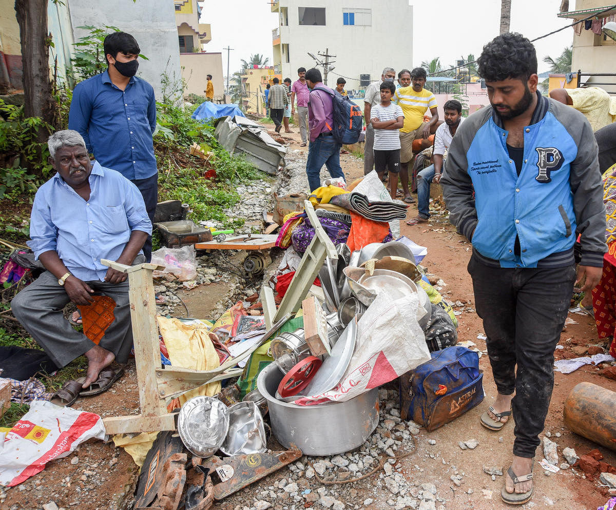 Residents trying to salvage their belongings. Credit: DH Photo